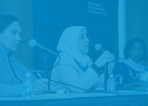 photo of three international women of courage awardees speaking at the Elliott School with a blue overlay