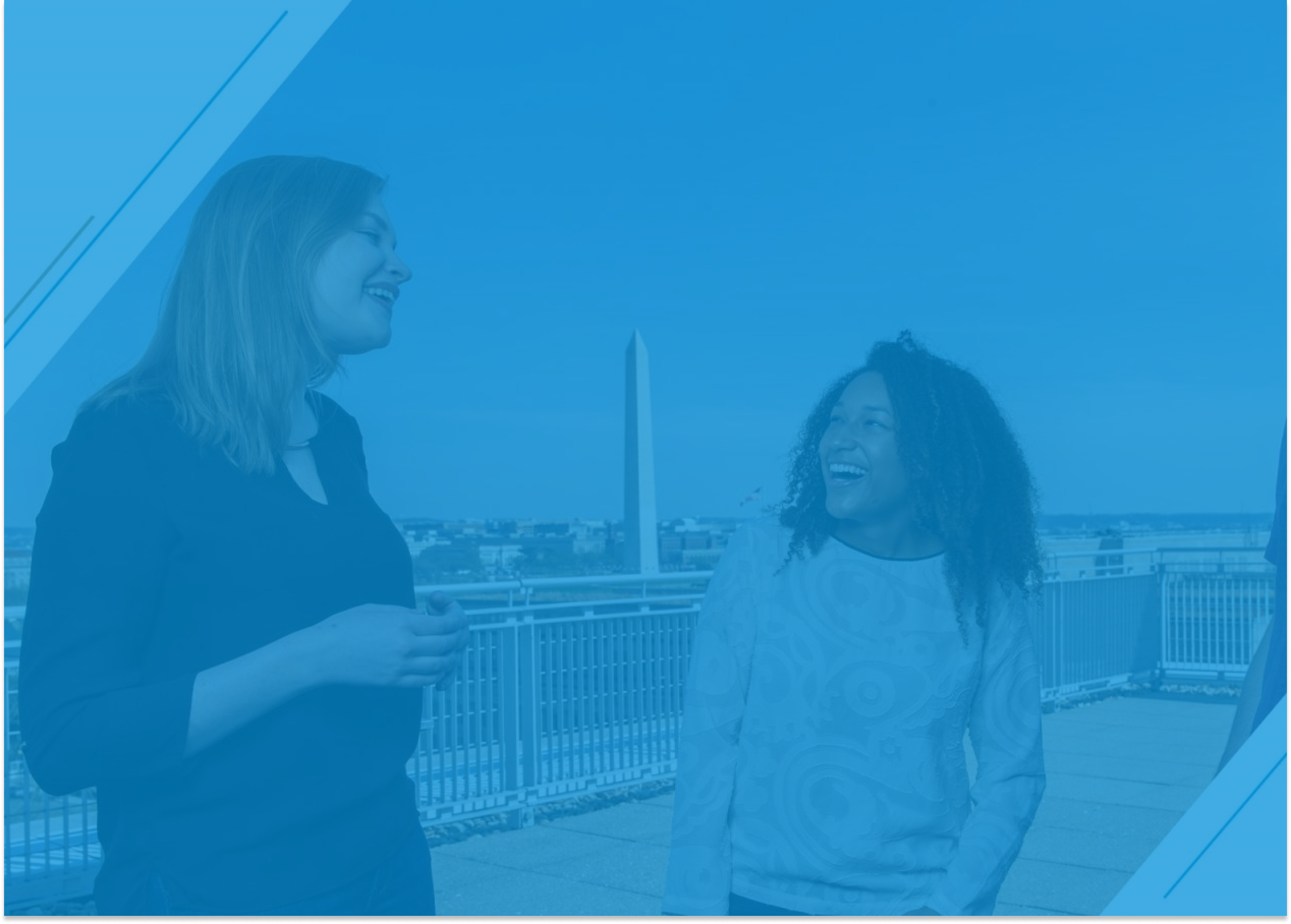 Two students talking on the top floor of the Elliott building overlooking the Washington Monument with a light blue overlay.