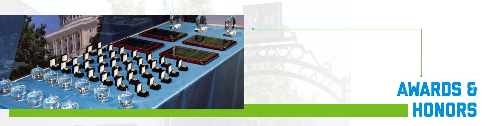 Awards and honors set on a blue table.