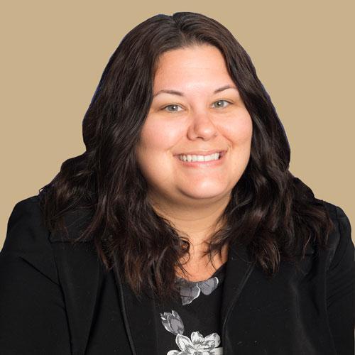 Nicole Campbell smiles. She is wearing a black blazer and black shirt.