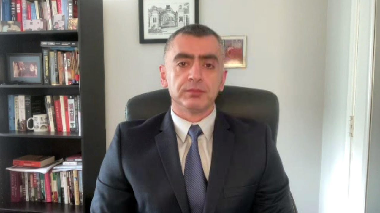 Sina Azodi sitting in office on interview with TRT.