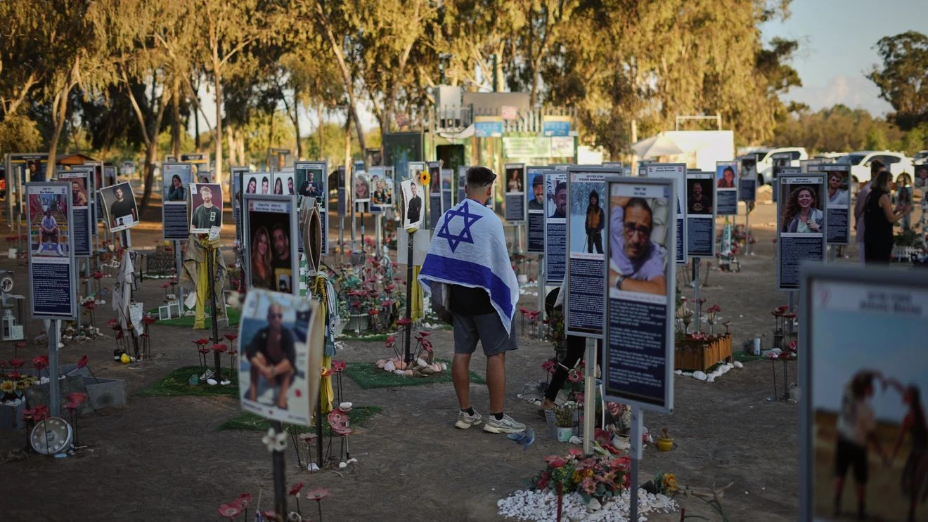 People visit the site of the Nova music festival, where hundreds of revelers were killed and abducted by Hamas and taken into Gaza, as Israel marks the second year anniversary of the attack, near Kibbutz Reim, southern Israel, Tuesday, Oct. 7, 2025. 