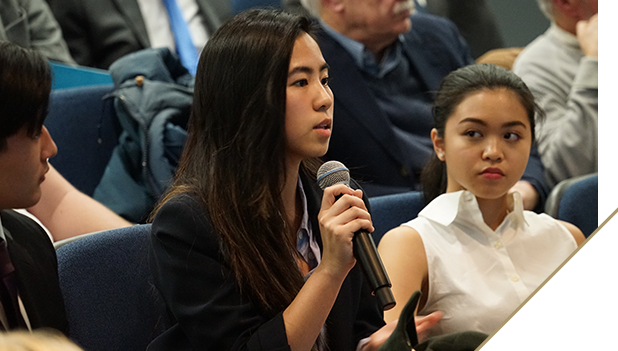 Photo: Woman asking question with a microphone