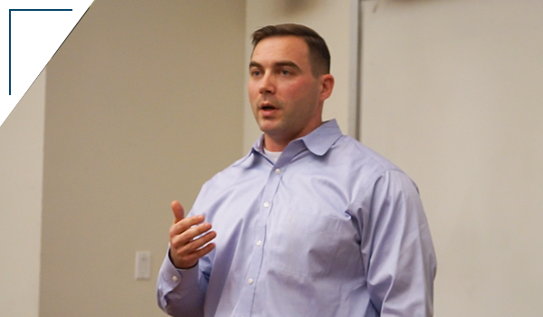Photo: A close up shot of an SPS student presenting his capstone project in a lecture hall
