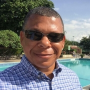 Photo: Drake Warrick wearing sunglasses in front of a pool on a sunny day