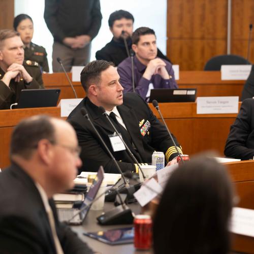 Military personnel having roundtable discussion.