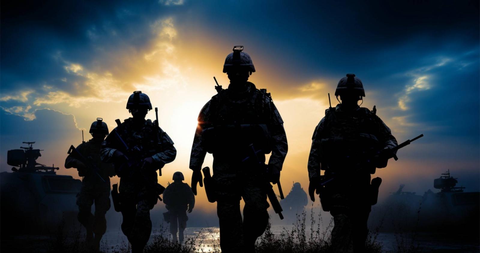 silhouette of soldiers walking with a sunrise in the background