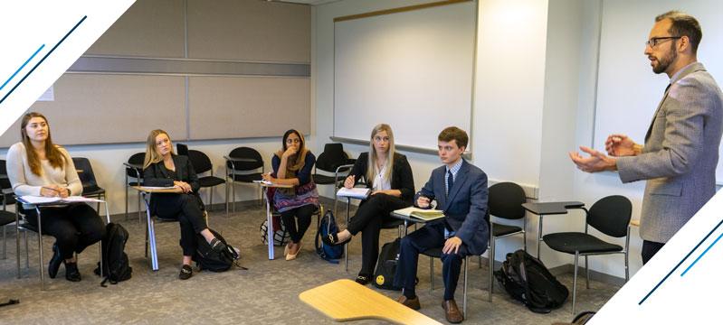 Deans Scholars class - the students observe the professor explaining a core concept