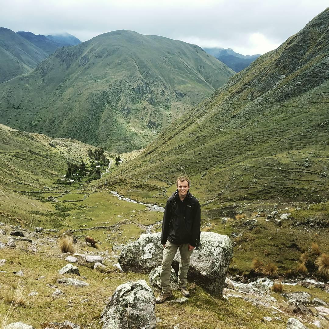 Eric Teller stands with a mountain range in view in the background