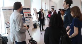 Students present posters at the Elliott School Research Showcase.