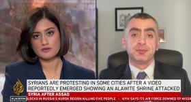 Sina Azodi sitting in office on interview with TRT. Interviewer to the left. 