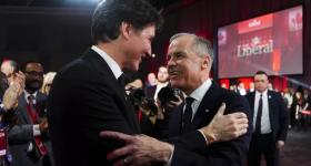 Mark Carney, right, speaks to Justin Trudeau after Carney was announced as the winner of the party leadership at the announcement event in Ottawa, Ontario