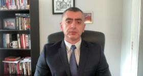 Sina Azodi sitting in office on interview with TRT.