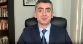 Sina Azodi sitting in office on interview with TRT.