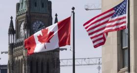 The Canadian and American flags displayed on lamp posts near Parliament Hill in Ottawa, Ontario, Canada on Mar 22, 2023. (Adrian Wyld/The Canadian Press via AP, File)