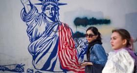Iranians pass by anti-American murals painted on the walls of the former U.S. embassy in Tehran, Iran on April 16. 